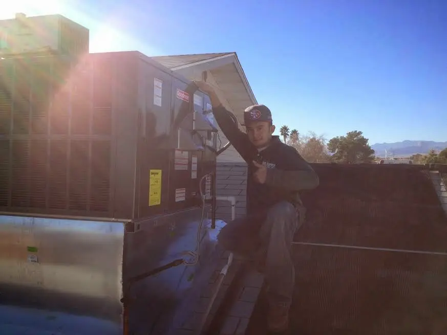 HVAC technician performing HVAC Inspection on a rooftop unit in Jaffrey